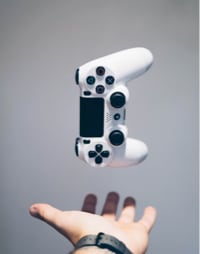 Hand tossing a playstation controller in the air..